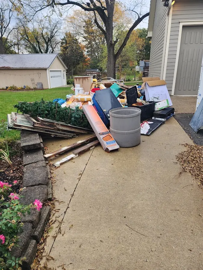 Dumpster being loaded with debris for 30 Yard Dumpster Rental in Troy